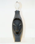 Side look of Maleras Crystal Electra Black Decanter from Masque collection with shade of yellow light on it on a white back ground for modern interiors available at Spacio India Bar Accessories Collection.