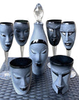 Maleras Crystal Electra Black Decanter with other drink ware accessories and Electra decanter from Masque collection on a woven table ground for modern interiors available at Spacio India from Bar Accessories Collection.